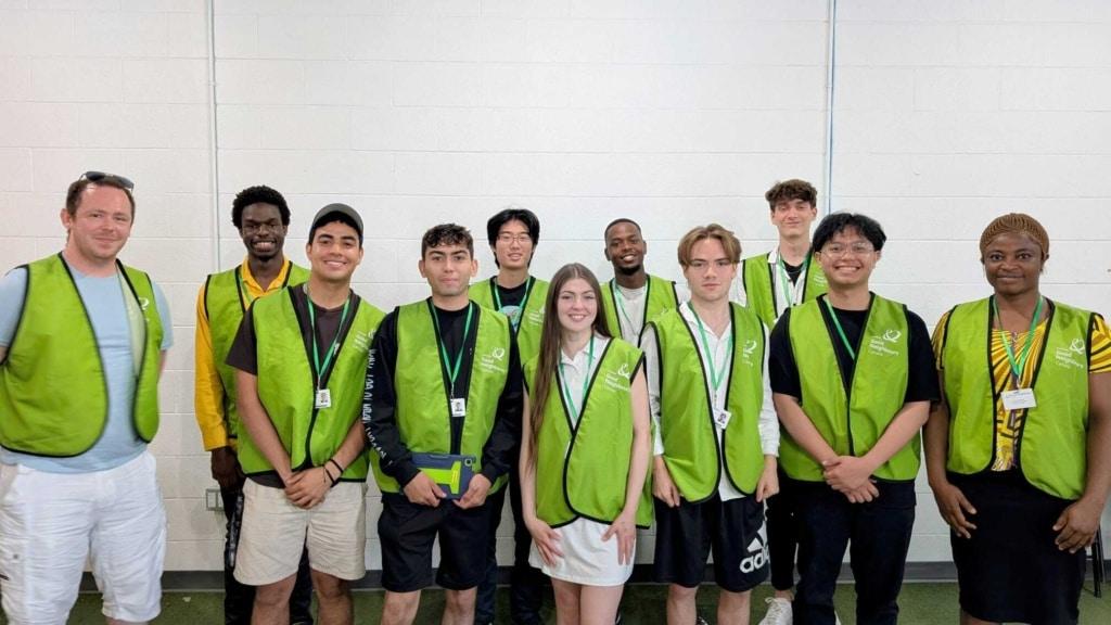 Our door-to-door team wearing green vests with the Good Neighbours logo