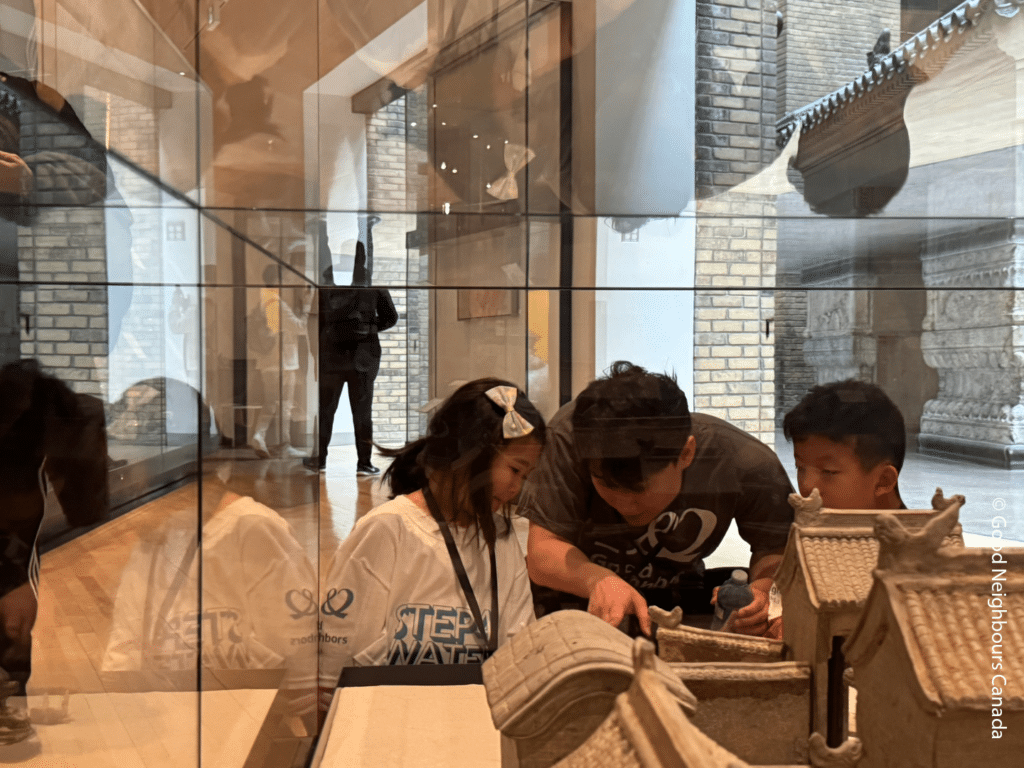 Volunteer HS Kim looking at displays with a PATH child.